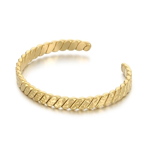 Polished gold stainless steel C-shaped open bracelet with twisted spiral texture