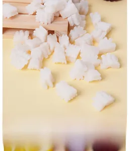 Detailed macro view of white miniature PVC squid rolls with realistic textured carvings