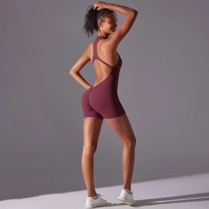 Close-up of wine red backless yoga jumpsuit featuring cross-straps and high stretch fabric