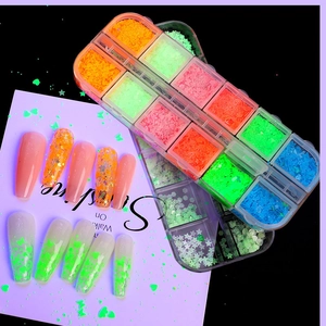 Luminous nail art sequins set in 12-grid box with glowing stars and heart shapes