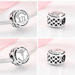 Macro view of S925 silver charms with Direito and Medicina engravings for bracelets