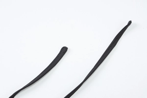 Close-up detail of black fabric shoulder straps with visible texture and fine stitching