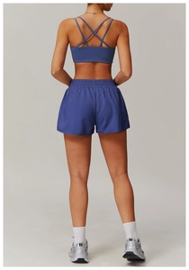 Rear view of dark blue yoga set with criss-cross back sports bra and high-waisted shorts