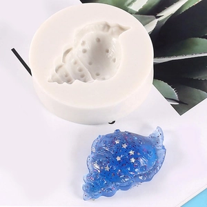 Conch shell silicone mold for DIY baking and resin crafts with a blue glitter finished piece