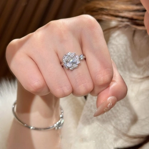 Sparkling zircon flower open ring in silver tone worn by a model for a luxury look