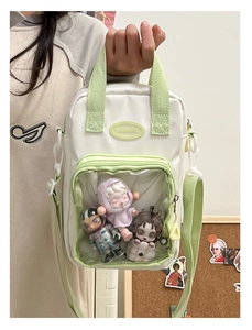 White and green ita bag with clear PVC window and adjustable strap for doll display