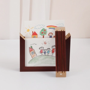 Close-up of a dark wood children art frame displaying a colorful rainbow painting