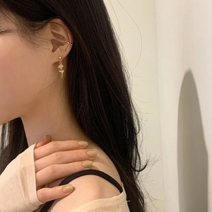 Golden rose earring and ear cuff set on model in elegant minimalist style