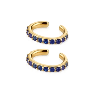 Detail of C-shaped gold ear cuff earrings with sparkling blue round gemstone inlay