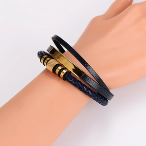 Detail of navy blue multi-layer braided leather bracelet with gold magnetic buckle