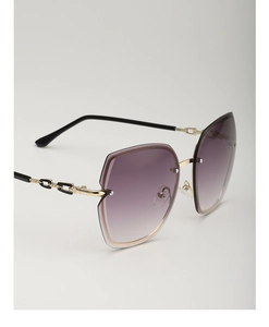 Detail view of rimless gradient sunglasses featuring chic metal chain temples in black and gold