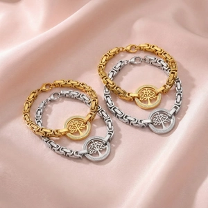 Detail of Tree of Life bracelet with crystals on pink satin background in gold and silver