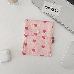 Detail of pink heart printed canvas tote bag with snap button and brand woven label