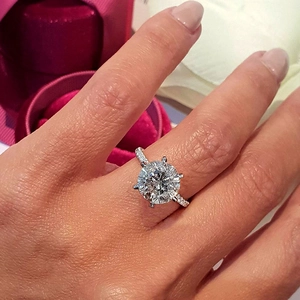 Classic six-prong solitaire ring with round cubic zirconia and pavé diamond band