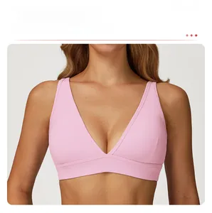 Détail de la brassière de sport rose montrant l'encolure en V profonde et le tissu doux