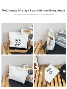 Detail view of white canvas crossbody bag with emoji print and brown strap