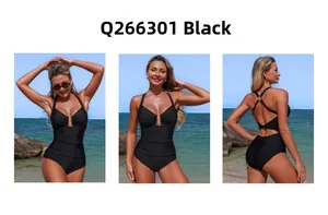 Detail of black one-piece swimsuit featuring crossover halter neck and gold ring hardware