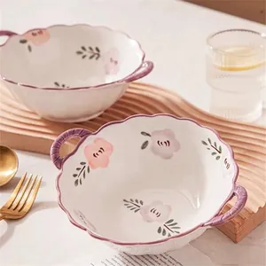 Elegant white petal shaped ceramic bowl with purple handles and interior floral patterns