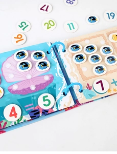 Detail view of Busy Book numbers learning page with colorful sea life and stickers