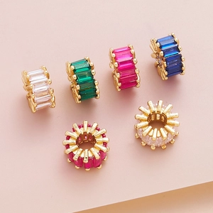 Macro shot of colorful zircon-inlaid brass beads with gold plating for jewelry DIY