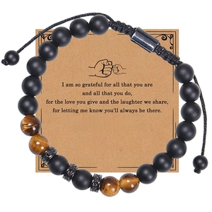 Detail of natural tiger eye and matte black beads on gift card for uncle