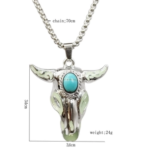Detailed view of silver ox skull necklace with turquoise stone and dimensions 3.4cm by 3.4cm