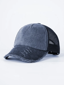 Detailed close-up of distressed vintage dark grey-blue denim trucker hat with mesh back
