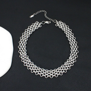 Close-up of wide braided stainless steel chain necklace with lobster clasp and extender