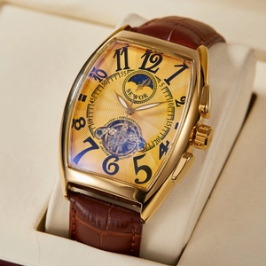 Golden tonneau mechanical watch with brown leather strap and skeleton moon phase dial