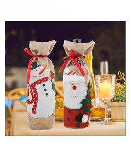 Detail of Christmas wine bottle covers featuring Santa and Snowman in a festive setting