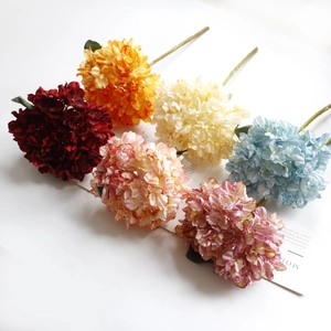 Flat lay of six artificial hydrangea stems in vibrant vintage oil painting colors