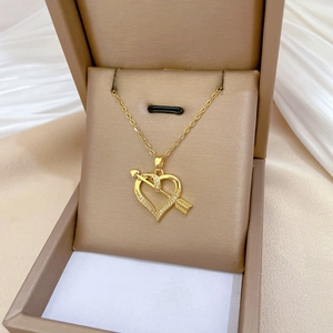Luxurious gold titanium heart arrow necklace with sparkling cubic zirconia in a jewelry box