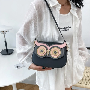 Cute black owl crossbody bag with colorful patchwork and rhinestone eye accents