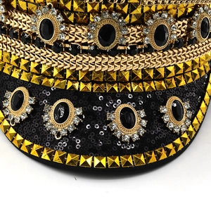 Close-up of bohemian festival captain hat featuring gold studs and black gemstones