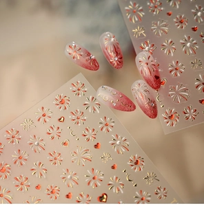 Macro view of festive red and gold fireworks heart nail stickers for New Year manicures