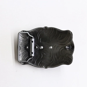 Detailed back view of vintage zinc alloy belt buckle showing western scroll patterns