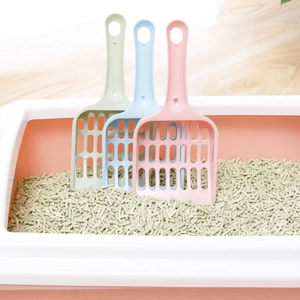 Three colorful plastic cat litter scoops in pink, blue, and green for pet cleaning