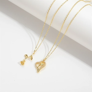Elegant gold rose pendant necklace and heart-shaped zircon necklace on white background