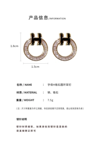 Detailed view of gold-plated H earrings with zircon accents and S925 silver needles