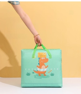 Detail of green storage bag featuring a cartoon dinosaur and reinforced wide handles