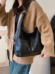 Large capacity black leather tote bag with adjustable strap and decorative stitching