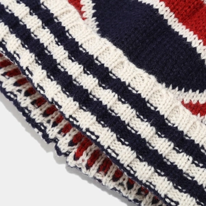 Macro detail of striped beige and navy knit fabric on winter hat scarf set
