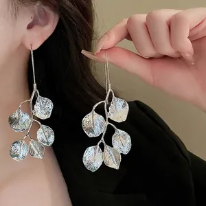 Silver leaf dangle earrings with intricate vine leaf texture in a minimalist metal design