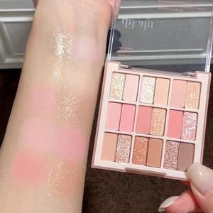 Arm swatches of 15-color eyeshadow palette with matte and shimmer pink tones