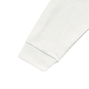 Close-up detail of white long-sleeved jacket cuff showing premium twill fabric texture