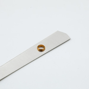 Precision gold brass bushings and aluminum clock movement parts on silver display metal