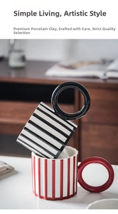 Detail of creative ceramic mugs with large round handles in stripe patterns