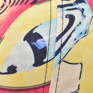 Macro view of geometric gradient twill fabric with pop art eye pattern and stitching