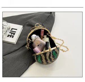 Detail view showing capacity of a spherical sequin clutch with wave pattern and chain