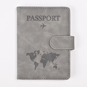 Macro detail of grey PU leather passport holder with world map design and buckle closure